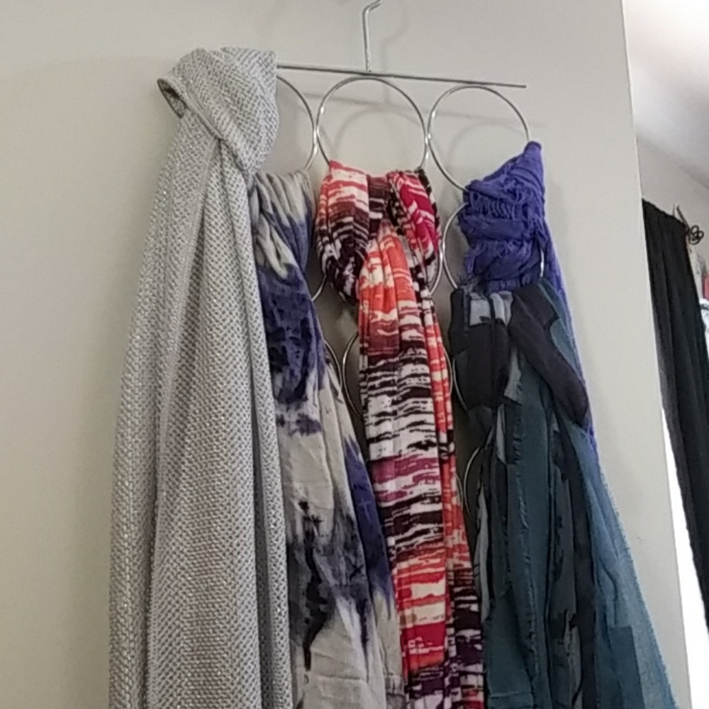 5 scarfs, 2 are new with tags. With scarf hanger